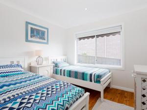Posteľ alebo postele v izbe v ubytovaní Rubys Retreat, 44 Achilles Street - pet friendly, aircon, wifi & boat parking