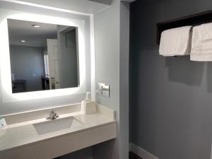 a bathroom with a sink and a mirror at Regency Motel in Brea