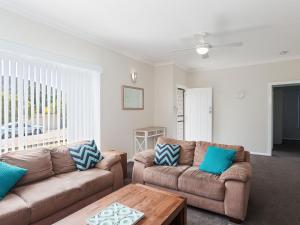 A seating area at Sandy Shoal', 46 Rigney Street - Shoal Bay Beach Cottage with aircon