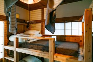 a bedroom with two bunk beds in a cabin at 1166 Backpackers in Nagano