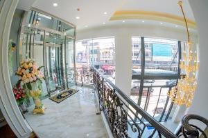 a lobby with a staircase with flowers on it at The MACEO Hotel in Nong Khai