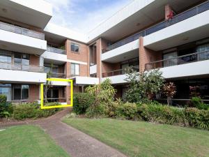 an apartment building with a lawn in front of it at The Commodore, 14, 9-11 Donald Street- Unit in the heart of town with views & free wi-fi in Nelson Bay