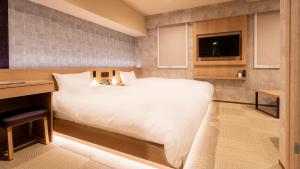 เตียงในห้องที่ Galois Hotel Shinokubo