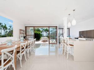 a kitchen and dining room with a table and chairs at The Moorings 15 stunning with water views and pool in Soldiers Point