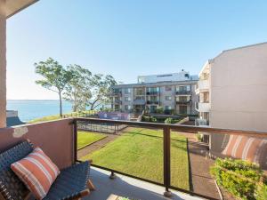 an apartment balcony with a view of the ocean at The Poplars, 24,36 Magnus Street - Unit with views, air con and wifi in a complex with a pool in Nelson Bay