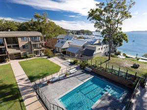 an aerial view of a house and a swimming pool at The Poplars, 6,36 Magnus Street - Unit with fabulous views and a complex pool in Nelson Bay