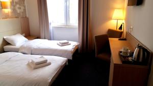 Posteľ alebo postele v izbe v ubytovaní Hotel Nadodrzański Dwór - Nowa Sól
