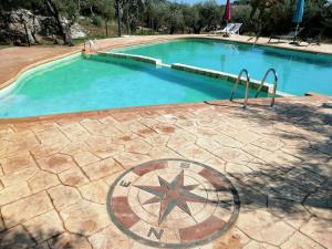a large swimming pool with a star in the middle at Recidence Villa Olivia in Itri