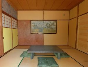 a room with a table in the corner of a room at Shirokuma Inn in Toyama