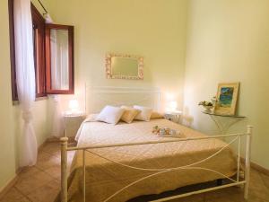 a bedroom with a bed with two lamps on it at Villa Sweet Simius in Villasimius