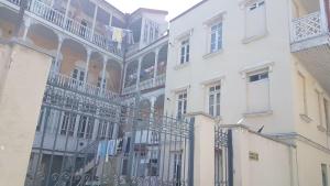 a row of white buildings with balconies and flags at AZAT НОМЕ in Tbilisi City