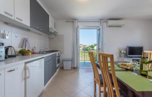 a kitchen with a table and a dining room at Apartment Nensi in Poreč