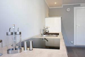 a kitchen with a sink and a counter top at Via Mare in Ginosa Marina +38 photos