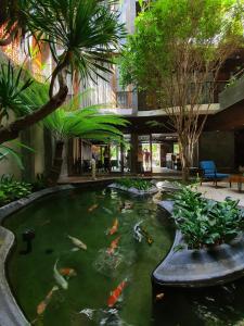 a koi pond in the middle of a building at Minh Boutique in Danang