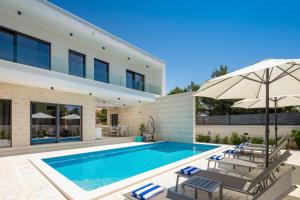 a swimming pool in the backyard of a house at VILLA DM in Vodice