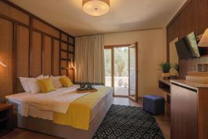 a hotel room with a bed and a television at Skiathos Avaton Hotel, Philian Hotels & Resorts in Skiathos