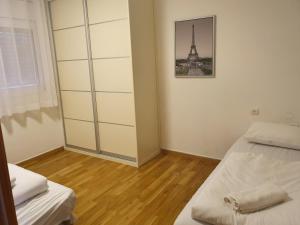 a bedroom with two beds and a picture of the eiffel tower at Adi in the desert in Arad