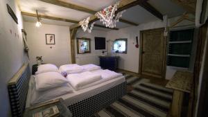 a bedroom with a large bed with white pillows at Iz de Maramures Rural Hotel in Şurdeşti