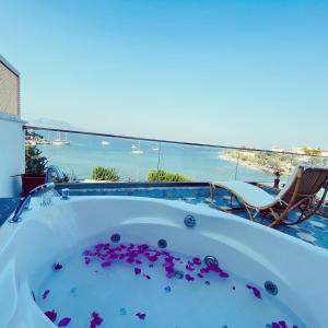a jacuzzi tub with a view of the ocean at Kumluk Hotel in Datca