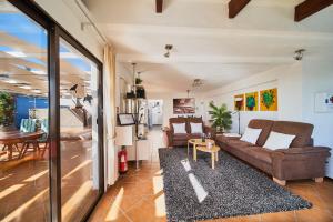 a living room with a couch and a table at Finca Stemann in Guía de Isora