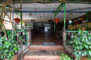 a corridor of a building with plants and a staircase at Mukda Guesthouse in Trat