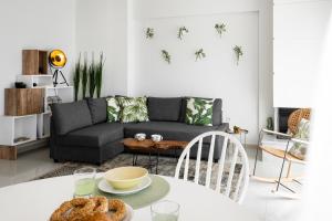 a living room with a couch and a table at Soleil Epanomi in Epanomi