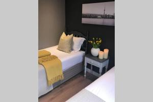 a bedroom with a bed with a yellow blanket at Winner in the Winelands in Franschhoek