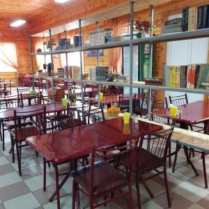a dining room with red tables and chairs at Nika2 Hotel in Zatoka