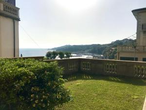 a view of the ocean from the balcony of a house at Appartamenti fronte mare in Castiglioncello