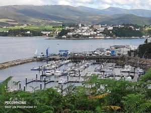 a group of boats docked at a marina on a lake at La Mariña in Ribadeo