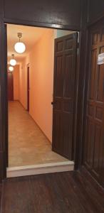 an empty hallway with two open doors and a hallwayngth at Apartamentos La Panerona Centro in Tineo