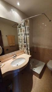 a bathroom with a sink and a shower and a toilet at Hotel Villa Bora in Sunny Beach