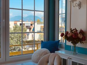 a room with a window with a view of a city at Olive Tree in Tirana
