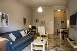 a living room with a couch and a table at D Zen Family Apartment Nafplio in Nafplio