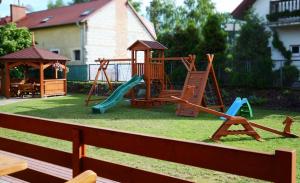 a playground with a slide and a gazebo at Słoneczna Dolina in Kąty Rybackie