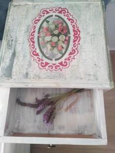 a box with a picture of flowers on it at Kapetanios Luxury in Agios Georgios