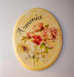 a clock with flowers on it with the word normal at Kapetanios Luxury in Agios Georgios