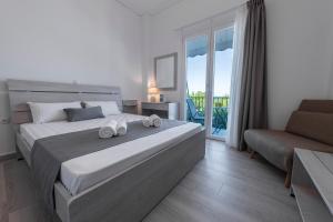 a bedroom with a large bed with towels on it at Paraskevas Boutique Hotel in Tyros