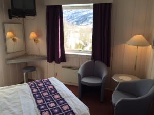 um quarto de hotel com uma cama e uma janela em Eikum Hotel em Hafslo