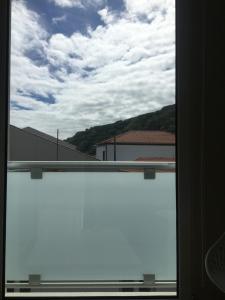 a view of a window with a view of a building at Cantinho do Sonho in Maia