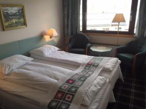 Postel nebo postele na pokoji v ubytování Eikum Hotel