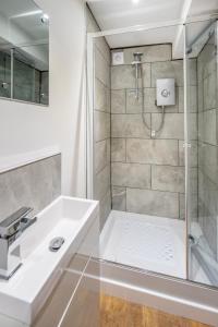 a bathroom with a shower and a sink at Knavesmire Studio in York