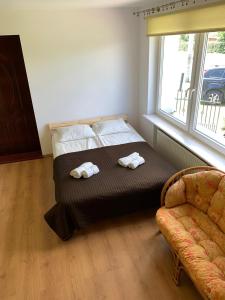 Postel nebo postele na pokoji v ubytování Mazury Apartament