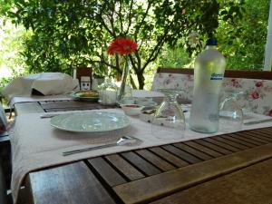 a wooden table with a bottle of water on it at Adabella Pension in Cıralı