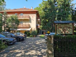 a building with cars parked in front of it at Villa Dorottya in Balatonföldvár