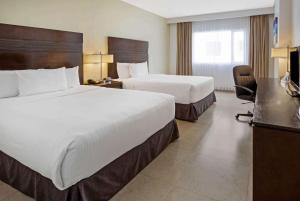 Postel nebo postele na pokoji v ubytování Wyndham Garden Cancun Downtown