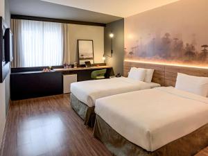 Cama ou camas em um quarto em Hotel Cassino Tower Curitiba Aeroporto By Nacional Inn