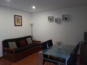 a living room with a table and a couch at Casa Ribom in Geres