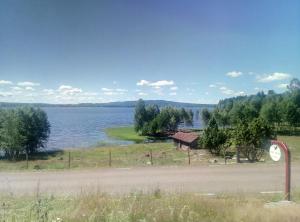 widok na jezioro z domem i drogą w obiekcie Dimgården w mieście Leksand