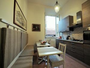 a kitchen with a table and a dining room at B&B Theodora in Frascati